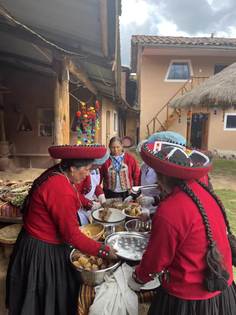 Cooks in traditional dress serving the pachamanca