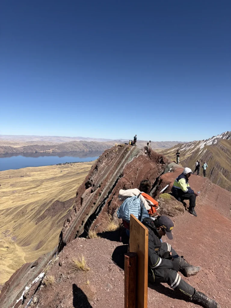 Travelers on the Pallay Punchu ridge with Langui Layo Lake in the background