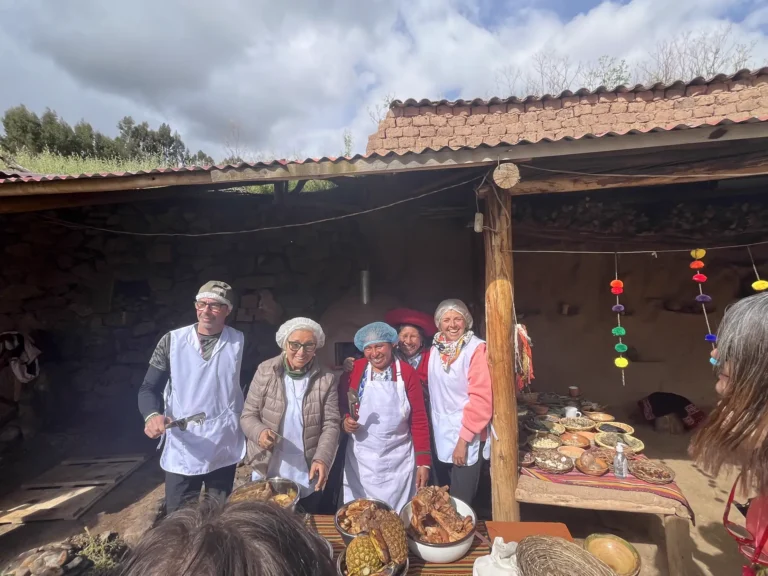 Travelers in aprons preparing the pachamanca with the local cooks